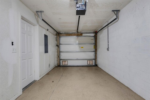 9013 White Sage Loop, Lakewood Ranch, FL 34202 - garage with electric panel, a garage door opener, and concrete block wall