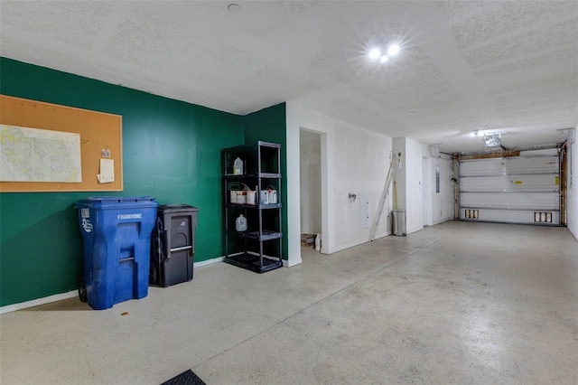9013 White Sage Loop, Lakewood Ranch, FL 34202 - garage featuring baseboards and a garage door opener