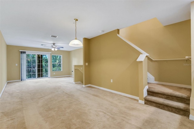 9013 White Sage Loop, Lakewood Ranch, FL 34202 - unfurnished living room with light colored carpet, baseboards, a ceiling fan, and stairs
