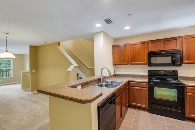 9013 White Sage Loop, Lakewood Ranch, FL 34202 - kitchen featuring black appliances, a sink, brown cabinetry, a peninsula, and recessed lighting