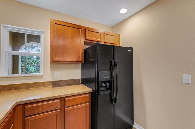 9013 White Sage Loop, Lakewood Ranch, FL 34202 - kitchen featuring black fridge with ice dispenser, brown cabinets, and recessed lighting