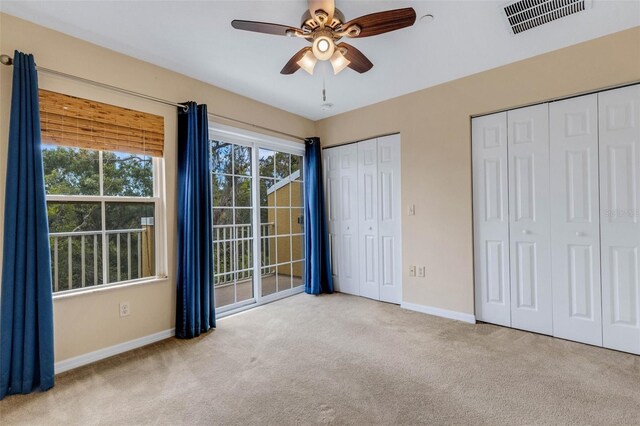 9013 White Sage Loop, Lakewood Ranch, FL 34202 - unfurnished bedroom with carpet, baseboards, multiple closets, and ceiling fan