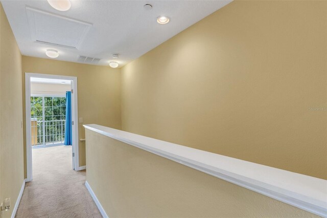 9013 White Sage Loop, Lakewood Ranch, FL 34202 - hallway featuring light colored carpet, baseboards, an upstairs landing, and attic access