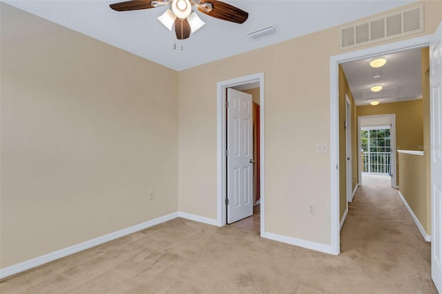 9013 White Sage Loop, Lakewood Ranch, FL 34202 - unfurnished bedroom with light colored carpet, baseboards, and ceiling fan