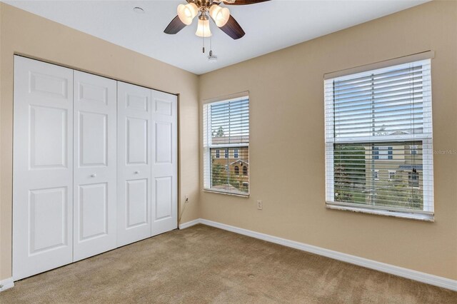 9013 White Sage Loop, Lakewood Ranch, FL 34202 - unfurnished bedroom with carpet floors, baseboards, a closet, and ceiling fan