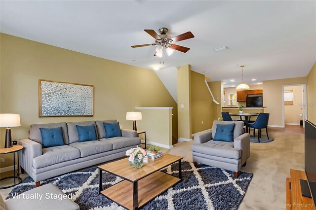 9013 White Sage Loop, Lakewood Ranch, FL 34202 - living area with baseboards, ceiling fan, and light colored carpet