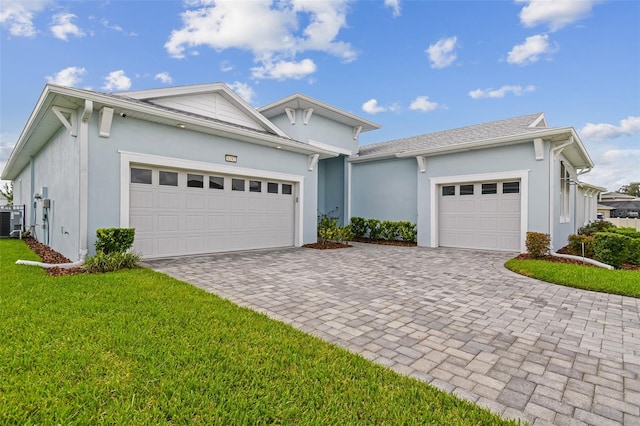 8192 Ivy Stark Blvd, Wesley Chapel, FL 33545 - view of front of house with a garage, stucco siding, decorative driveway, and a front lawn