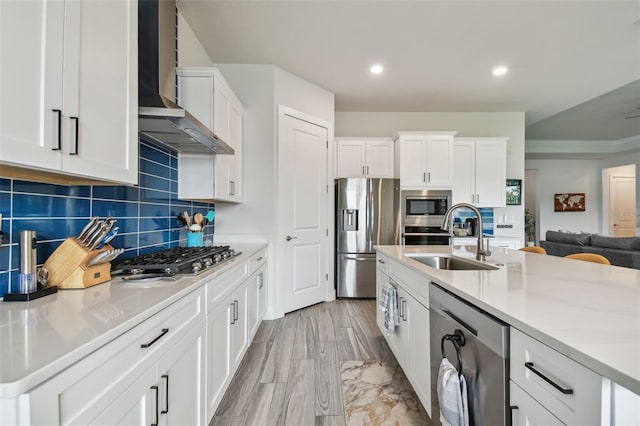 8192 Ivy Stark Blvd, Wesley Chapel, FL 33545 - kitchen with stainless steel appliances, wall chimney exhaust hood, a sink, light countertops, and white cabinetry