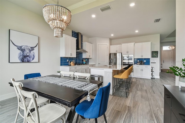 8192 Ivy Stark Blvd, Wesley Chapel, FL 33545 - dining area with a chandelier, baseboards, light wood-style floors, and recessed lighting
