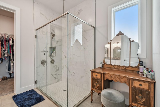 8192 Ivy Stark Blvd, Wesley Chapel, FL 33545 - full bathroom with a marble finish shower, a walk in closet, vanity, and tile patterned floors