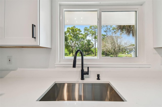695 Sunset Dr, Tarpon Springs, FL 34689 - kitchen view of a sink and white cabinetry