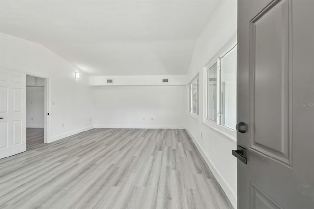 695 Sunset Dr, Tarpon Springs, FL 34689 - spare room with lofted ceiling, light wood finished floors, and baseboards