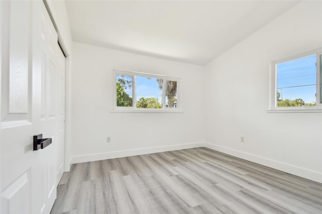 695 Sunset Dr, Tarpon Springs, FL 34689 - unfurnished bedroom featuring light wood-style flooring, baseboards, and a closet