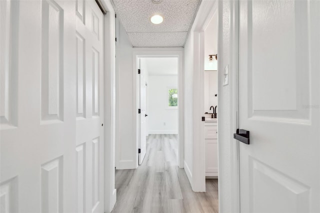 695 Sunset Dr, Tarpon Springs, FL 34689 - corridor with light wood-type flooring and baseboards
