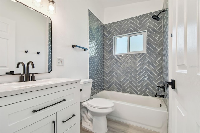 695 Sunset Dr, Tarpon Springs, FL 34689 - full bath with tub / shower combination, vanity, toilet, and wood finished floors