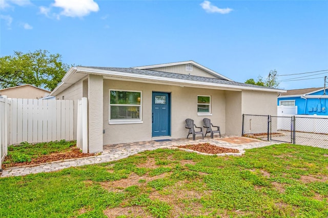 3927 Spence Ave, Tampa, FL 33614 - view of front of property with stucco siding, roof with shingles, and a gate