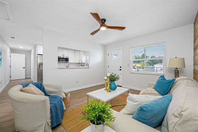 3927 Spence Ave, Tampa, FL 33614 - living area featuring a ceiling fan, wood finished floors, and baseboards