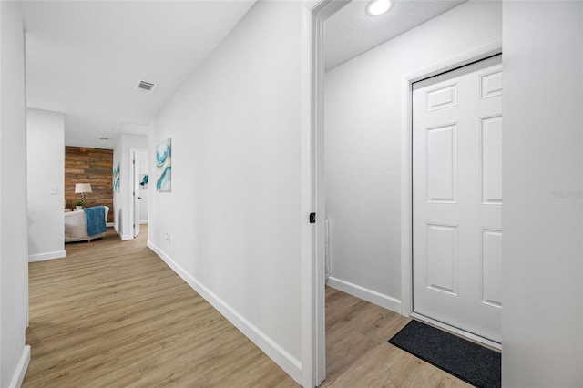 3927 Spence Ave, Tampa, FL 33614 - hall with light wood-style flooring and baseboards