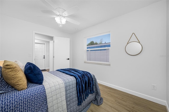 3927 Spence Ave, Tampa, FL 33614 - bedroom with wood finished floors, baseboards, and ceiling fan