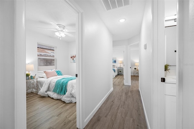 3927 Spence Ave, Tampa, FL 33614 - corridor with wood finished floors, baseboards, and recessed lighting