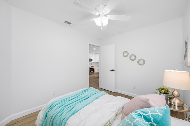 3927 Spence Ave, Tampa, FL 33614 - bedroom with baseboards, wood finished floors, and ceiling fan