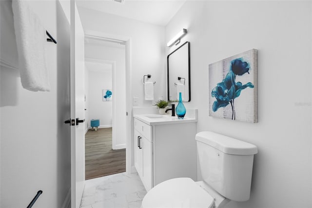 3927 Spence Ave, Tampa, FL 33614 - bathroom with vanity, marble look tile flooring, toilet, and baseboards