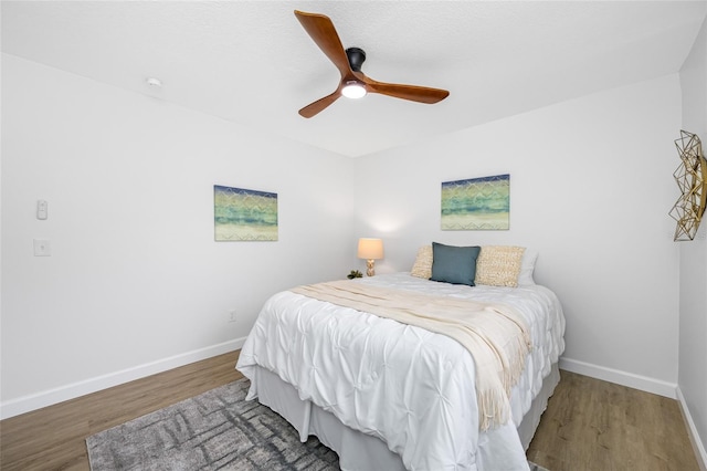 3927 Spence Ave, Tampa, FL 33614 - bedroom with wood finished floors, baseboards, and ceiling fan