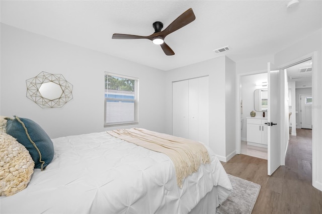 3927 Spence Ave, Tampa, FL 33614 - bedroom featuring wood finished floors, a closet, ceiling fan, and baseboards