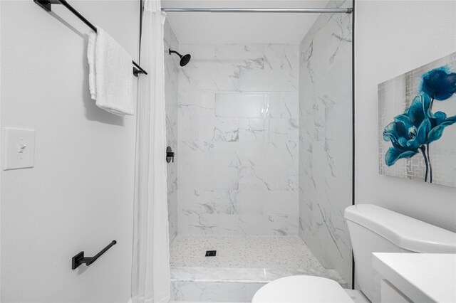 3927 Spence Ave, Tampa, FL 33614 - bathroom featuring vanity, toilet, and a marble finish shower