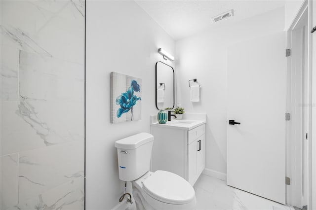 3927 Spence Ave, Tampa, FL 33614 - full bath with marble look tile flooring, vanity, toilet, and baseboards