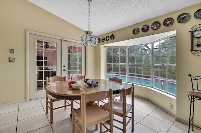 4388 Tiffin Ave, Spring Hill, FL 34609 - dining area featuring french doors, light tile patterned flooring, healthy amount of natural light, a textured ceiling, and lofted ceiling