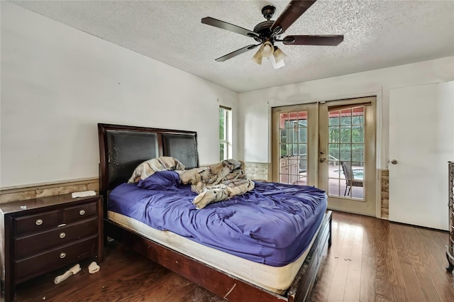 4388 Tiffin Ave, Spring Hill, FL 34609 - bedroom featuring french doors, a textured ceiling, access to outside, a wainscoted wall, and wood finished floors