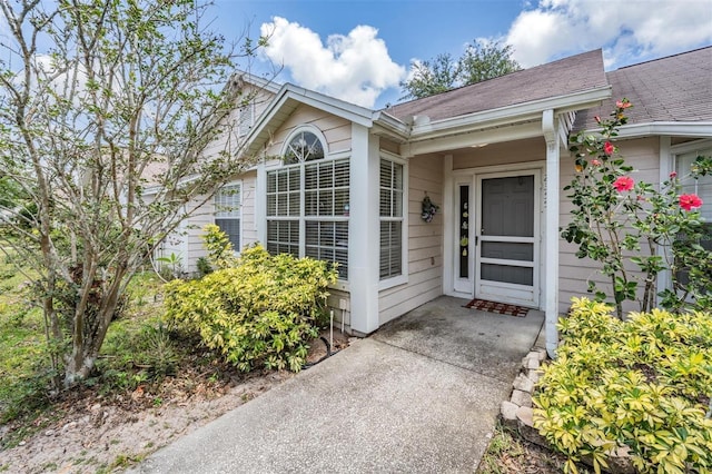 2355 Bentley Dr, Palm Harbor, FL 34684 - property entrance featuring a shingled roof