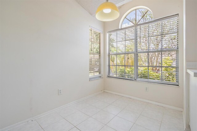 2355 Bentley Dr, Palm Harbor, FL 34684 - spare room with baseboards and light tile patterned floors