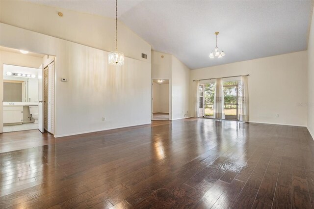 2355 Bentley Dr, Palm Harbor, FL 34684 - unfurnished living room with a chandelier, wood-type flooring, high vaulted ceiling, and baseboards