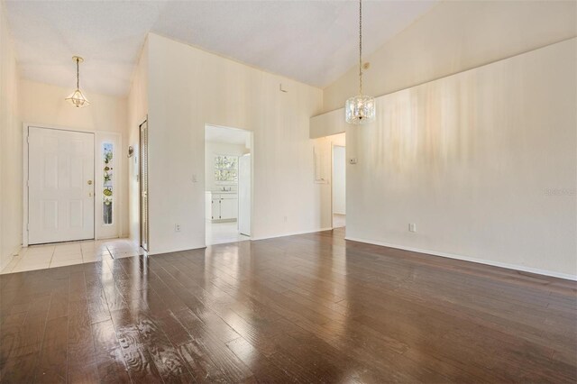 2355 Bentley Dr, Palm Harbor, FL 34684 - entryway featuring a chandelier, hardwood / wood-style floors, and high vaulted ceiling