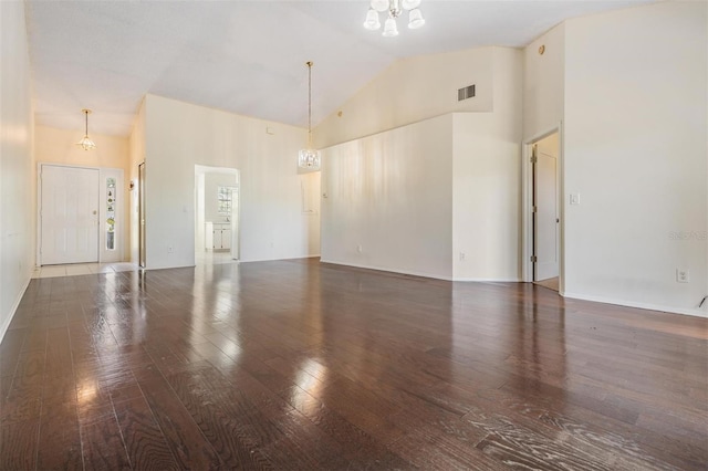 2355 Bentley Dr, Palm Harbor, FL 34684 - unfurnished living room featuring hardwood / wood-style floors, high vaulted ceiling, and a chandelier