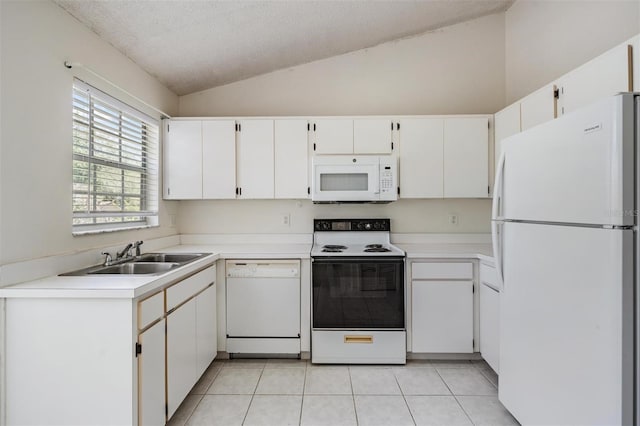 2355 Bentley Dr, Palm Harbor, FL 34684 - kitchen with white appliances, vaulted ceiling, a sink, a textured ceiling, and light tile patterned flooring