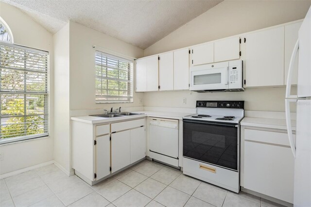 2355 Bentley Dr, Palm Harbor, FL 34684 - kitchen with white appliances, lofted ceiling, a sink, a textured ceiling, and light countertops