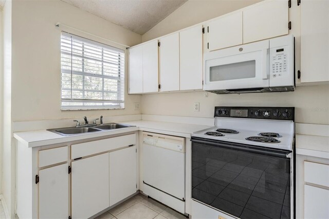 2355 Bentley Dr, Palm Harbor, FL 34684 - kitchen featuring white appliances, a sink, vaulted ceiling, a textured ceiling, and light countertops