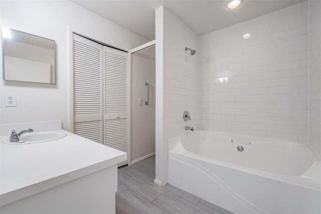 2355 Bentley Dr, Palm Harbor, FL 34684 - bathroom featuring vanity, shower / tub combination, and baseboards