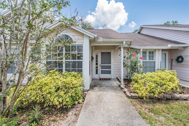2355 Bentley Dr, Palm Harbor, FL 34684 - doorway to property featuring roof with shingles