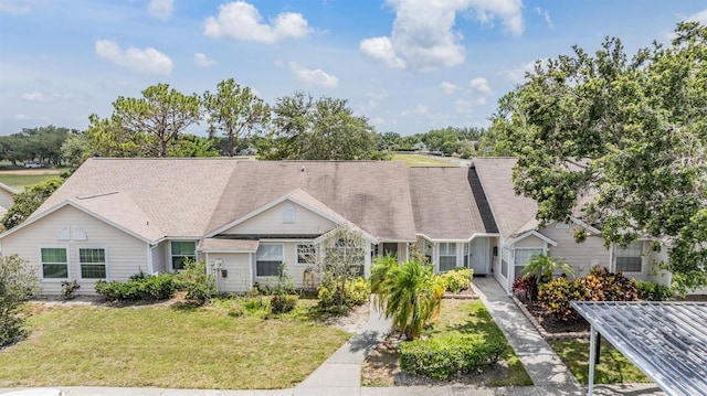 2355 Bentley Dr, Palm Harbor, FL 34684 - townhome / multi-family property with a front lawn and roof with shingles