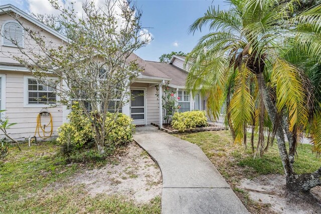 2355 Bentley Dr, Palm Harbor, FL 34684 - view of front facade featuring roof with shingles