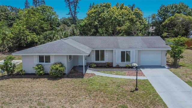 4502 19th Street Cir W, Bradenton, FL 34207 - ranch-style house with roof with shingles, a garage, a front lawn, driveway, and stucco siding