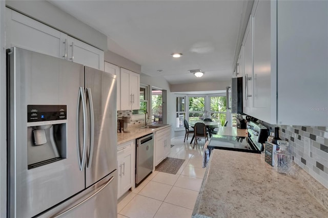 4502 19th Street Cir W, Bradenton, FL 34207 - kitchen featuring stainless steel appliances, backsplash, a sink, white cabinetry, and light tile patterned flooring