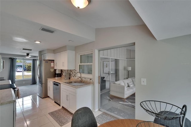 4502 19th Street Cir W, Bradenton, FL 34207 - kitchen featuring a sink, stainless steel appliances, white cabinets, light countertops, and backsplash