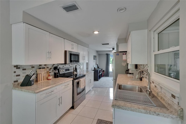 4502 19th Street Cir W, Bradenton, FL 34207 - kitchen with stainless steel appliances, tasteful backsplash, light countertops, white cabinets, and recessed lighting