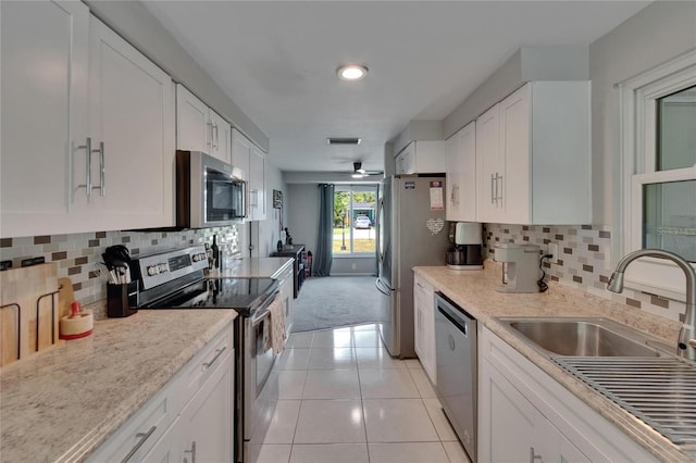 4502 19th Street Cir W, Bradenton, FL 34207 - kitchen with stainless steel appliances, a sink, white cabinetry, and backsplash