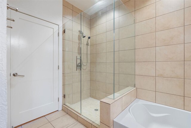 400 4th Ave S Unit 508, Saint Petersburg, FL 33701 - full bath featuring a shower stall, a bath, and tile patterned flooring
